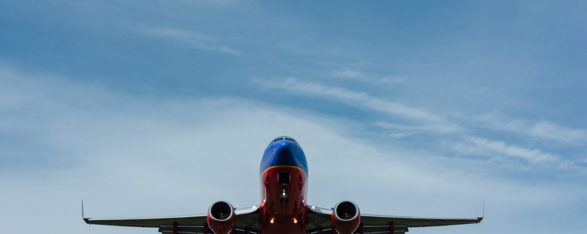 blue and red airplane on sky
